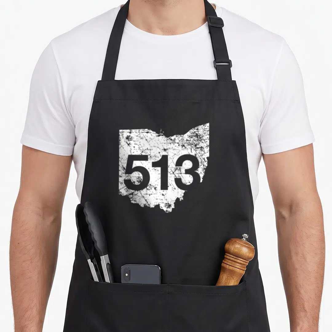 Cincinnati mason apron - Distressed white Ohio state outline with grey 513 number printed on front panel — shown on a black cotton canvas apron against a white background