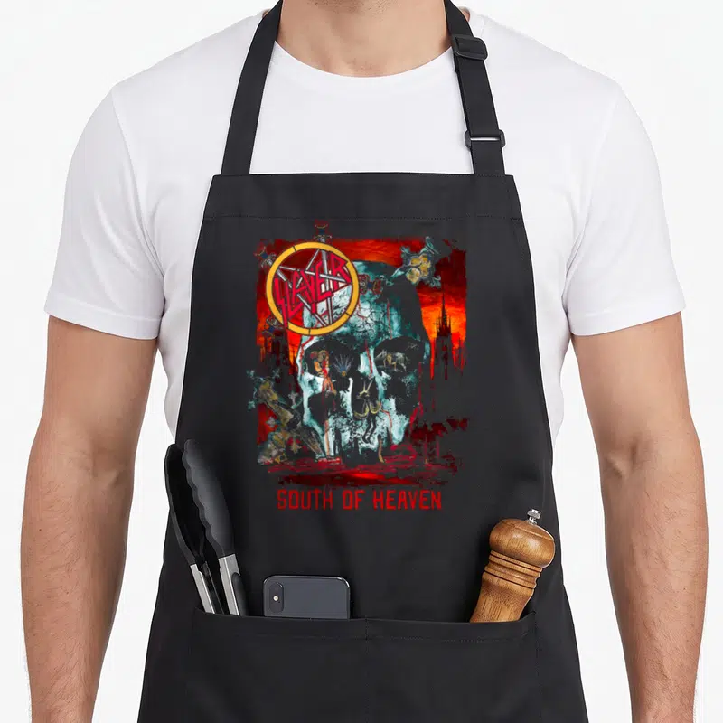 South skull apron - Distressed skull with red pentagram and SOUTH OF HEAVEN text — shown on a black cotton canvas apron against a white background