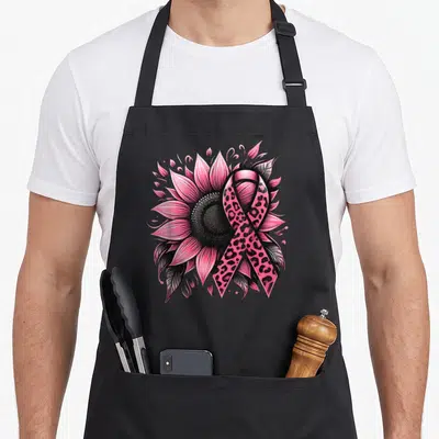Funny sunflower breast cancer awareness aprons - Pink sunflower with leopard print awareness ribbon and black leaves — shown on a black cotton canvas apron against a white background