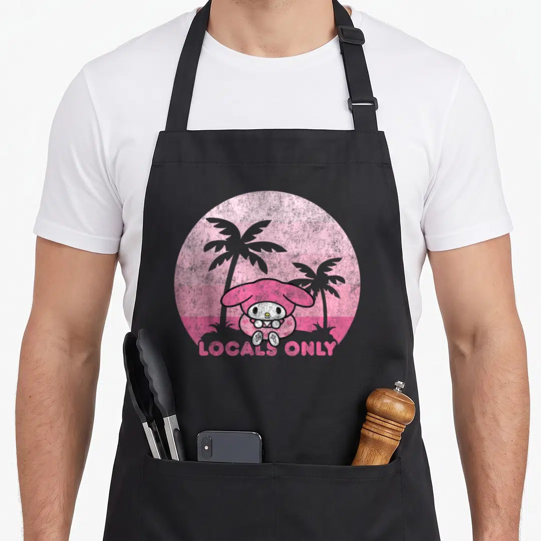 Local my melody apron - My Melody sits before two grey palm trees in a pink striped circle with LOCALS ONLY text below — shown on a black cotton canvas apron against a white background