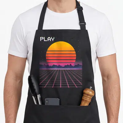 Grid 80s apron - Retro striped sun over purple mountains with pink grid and PLAY text — shown on a black cotton canvas apron against a white background
