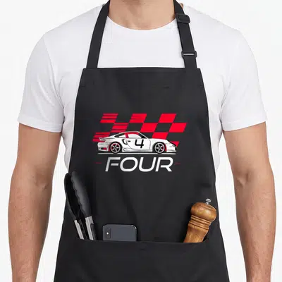 Race 4th car apron - White race car with number 4 and red checkered flag pattern — shown on a black cotton canvas apron against a white background