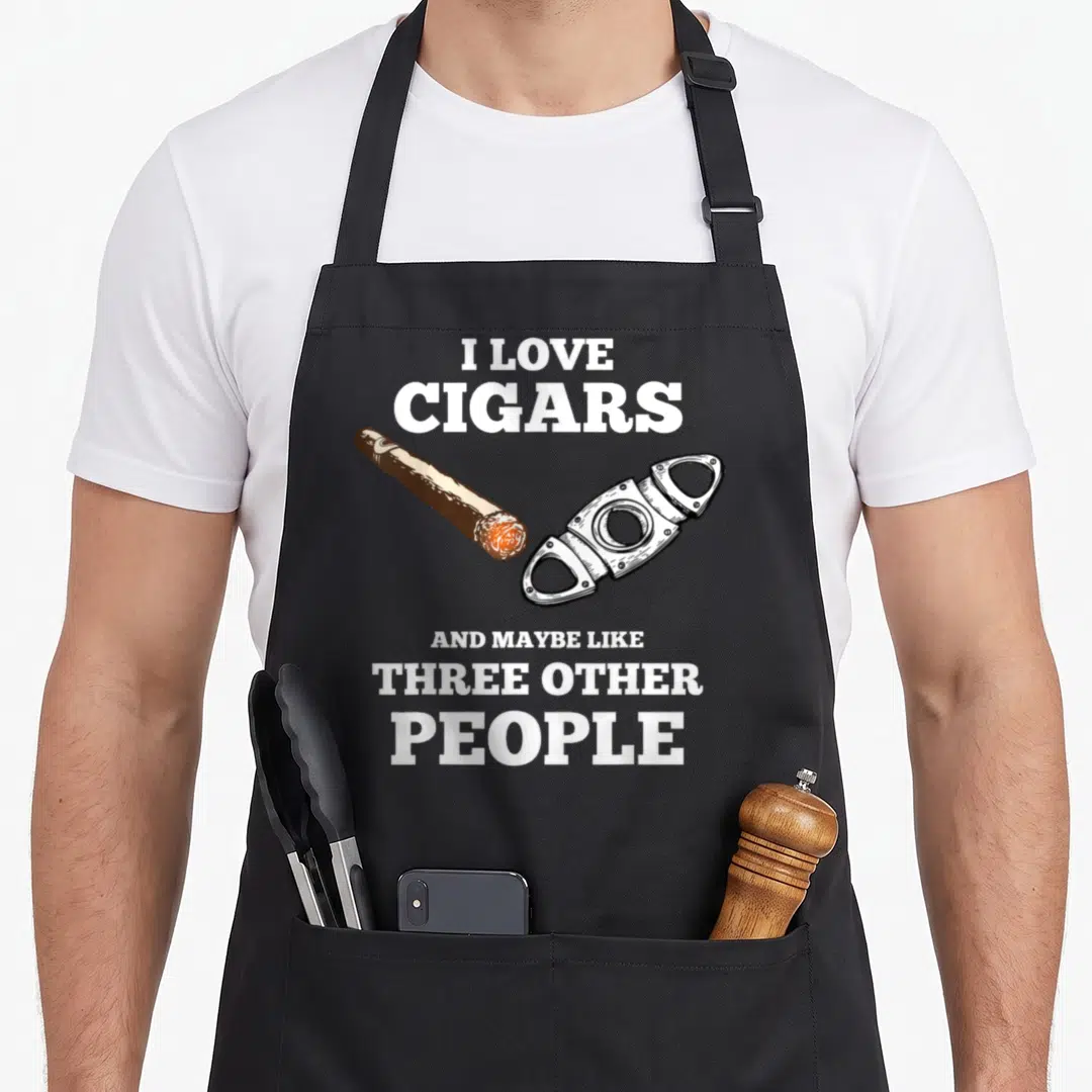 Cigar smoker apron - Sarcastic text surrounding a brown cigar and silver cutter on a grey background — shown on a black cotton canvas apron against a white background