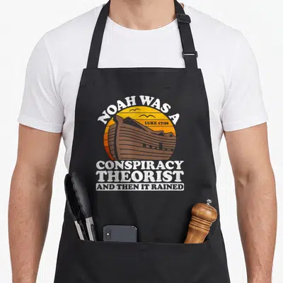 Conspiracy christian apron - Vintage ark in orange sun with two birds and distressed white text reading Noah was — shown on a black cotton canvas apron against a white background