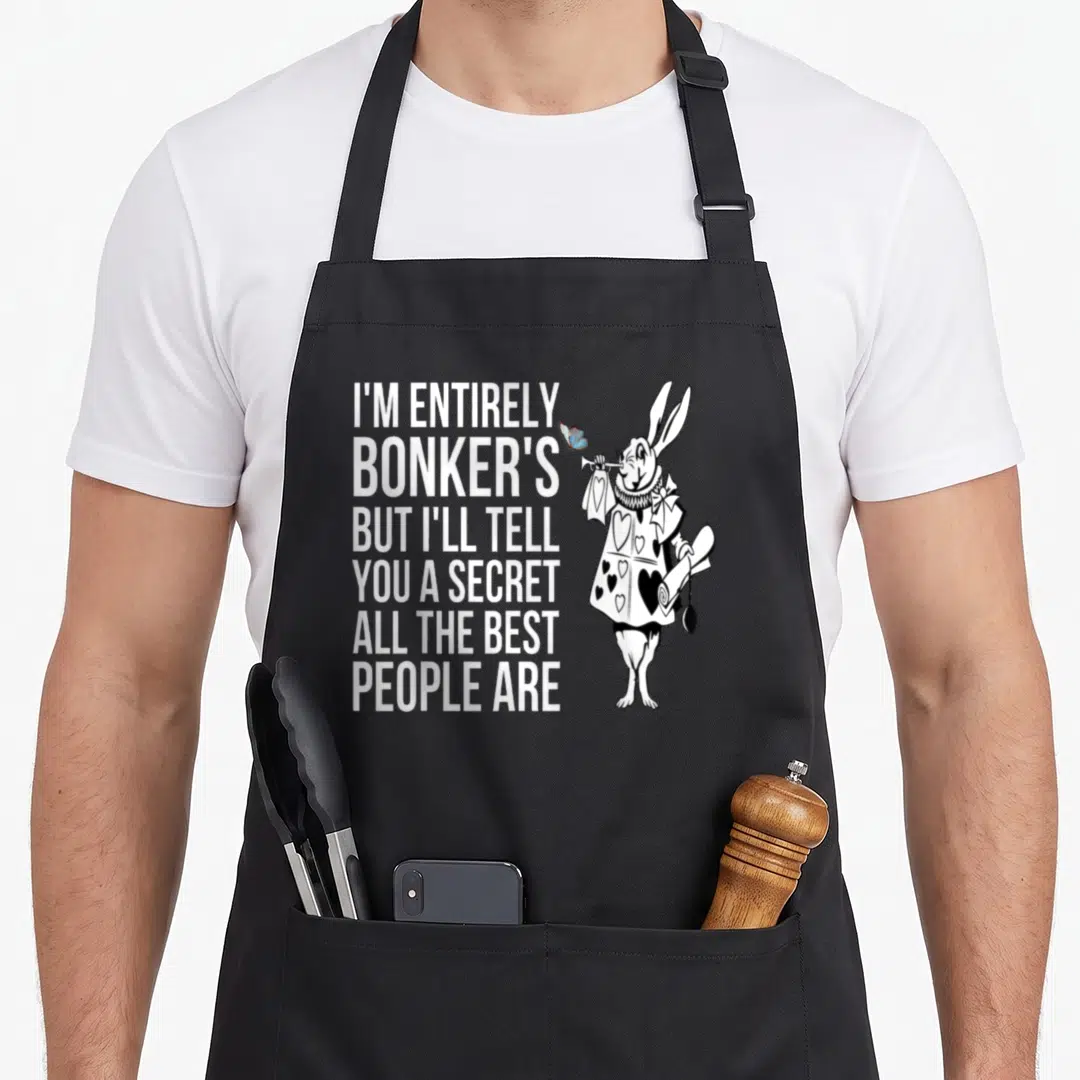 Vintage alice rabbit apron - Rabbit holding scroll with blue butterfly next to stacked white text quote — shown on a black cotton canvas apron against a white background