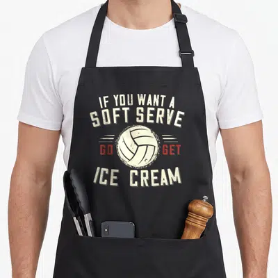 Retro volleyball apron - Distressed cream volleyball with red text IF YOU WANT A SOFT SERVE GO GET ICE CREAM — shown on a black cotton canvas apron against a white background