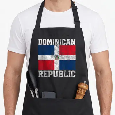 Republic country apron - Distressed Dominican Republic flag with text DOMINICAN REPUBLIC above and below — shown on a black cotton canvas apron against a white background