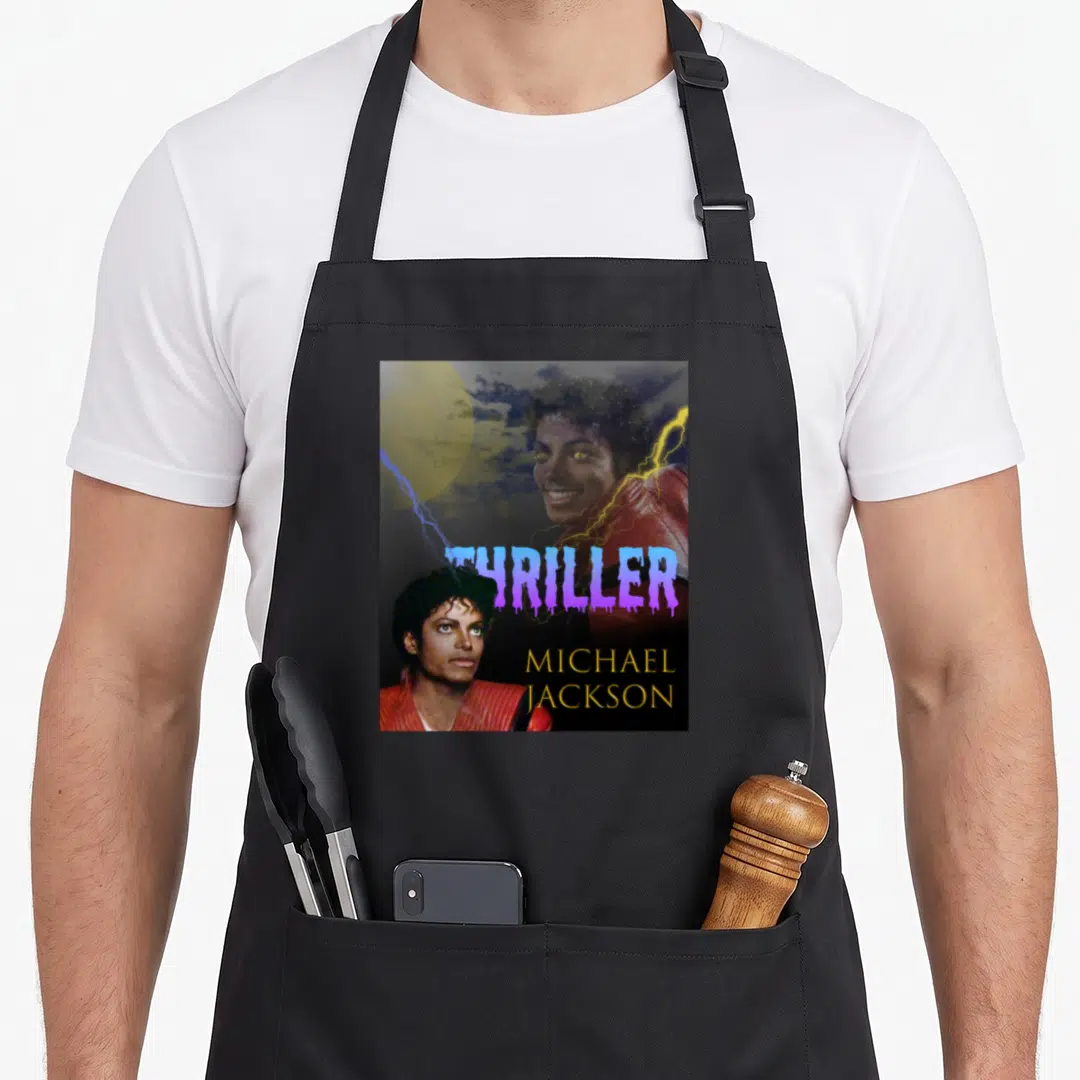 Cute thriller michaels apron - Two Michael Jackson photos over stormy sky with purple THRILLER and yellow name text — shown on a black cotton canvas apron against a white background
