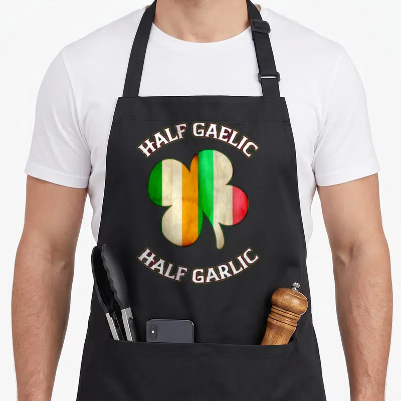 Italian st patrick day aprons - Shamrock split into Irish and Italian flag colors with arched text reading Half Gaelic — shown on a black cotton canvas apron against a white background