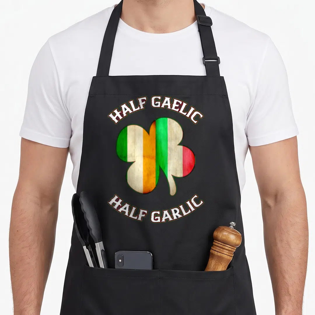Italian st patrick day aprons - Shamrock split into Irish and Italian flag colors with arched text reading Half Gaelic — shown on a black cotton canvas apron against a white background