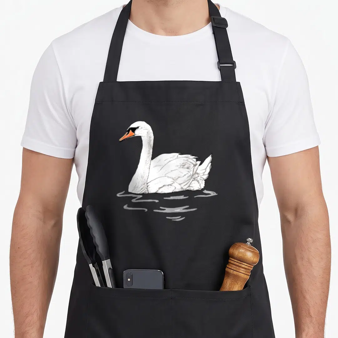 Funny animal swan apron - Line art of a white swan with orange beak floating on water ripples — shown on a black cotton canvas apron against a white background