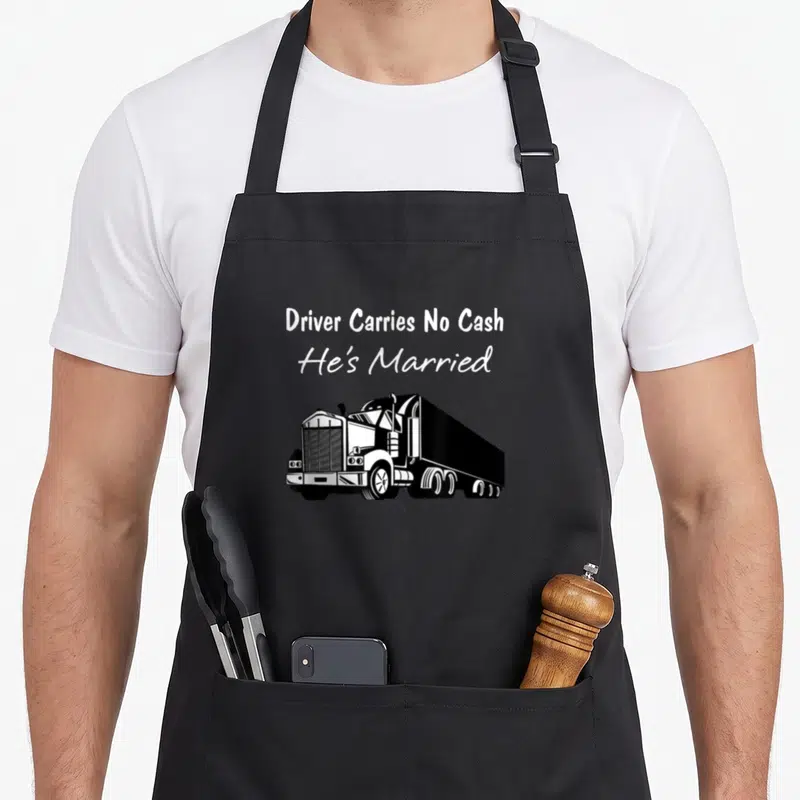 Driver cash and carry aprons - White text Driver Carries No Cash He's Married above a black semi-truck graphic — shown on a black cotton canvas apron against a white background