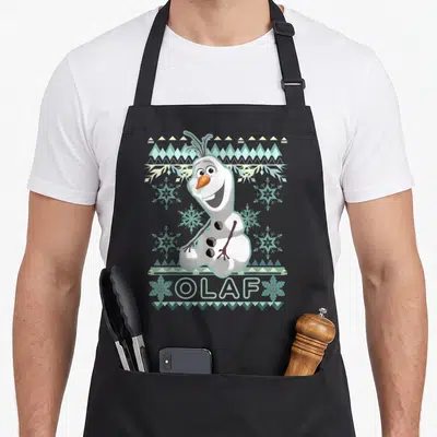 Olaf ugly christmas apron - Cartoon snowman with geometric border and stitched OLAF text in white blue orange — shown on a black cotton canvas apron against a white background