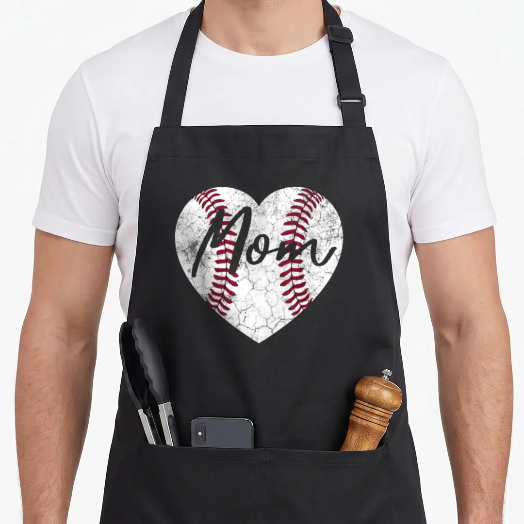Baseball softball mother's day aprons - Distressed white heart baseball with red stitching and grey Mom script text — shown on a black cotton canvas apron against a white background