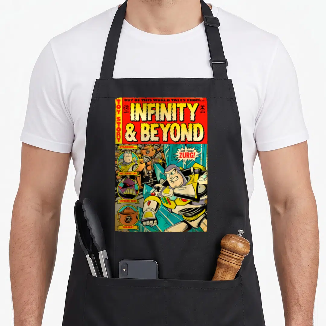 Comic camping apron - Retro comic book cover with Buzz Lightyear fighting Zurg and large yellow title text — shown on a black cotton canvas apron against a white background