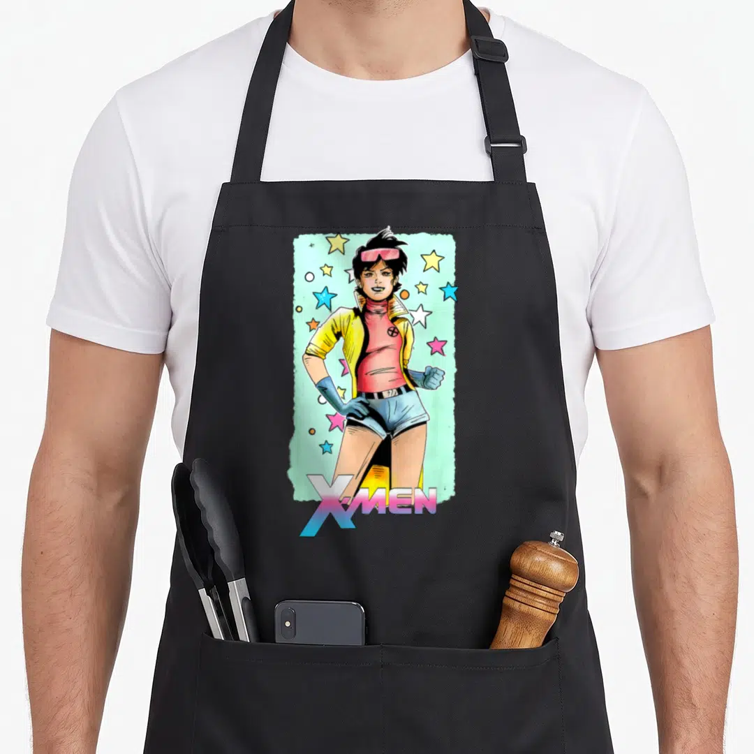 Jubilee x apron - Cartoon woman in yellow jacket and pink top surrounded by stars with X-MEN text below — shown on a black cotton canvas apron against a white background