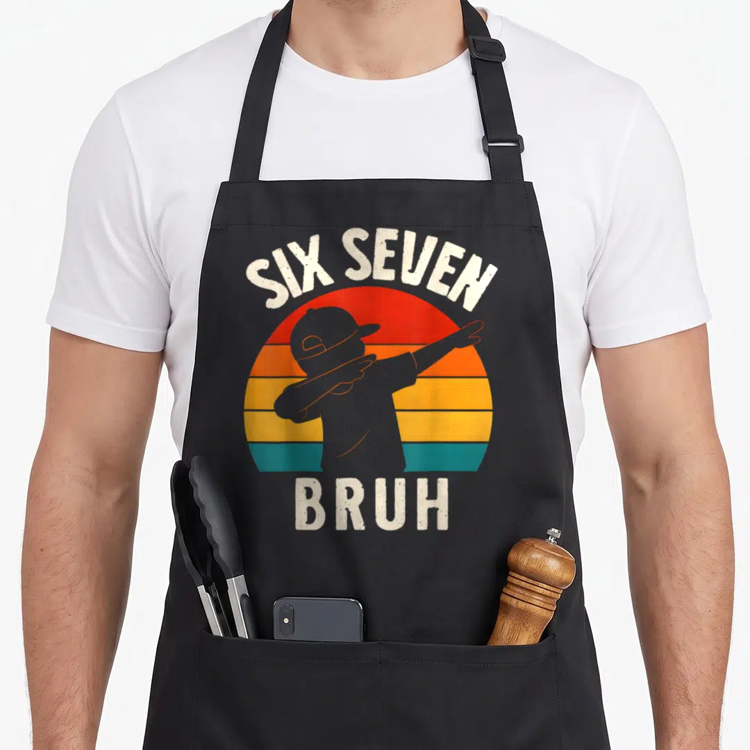 Number meme apron - Dabbing person silhouette under arched SIX SEVEN text over striped sun with BRUH below — shown on a black cotton canvas apron against a white background