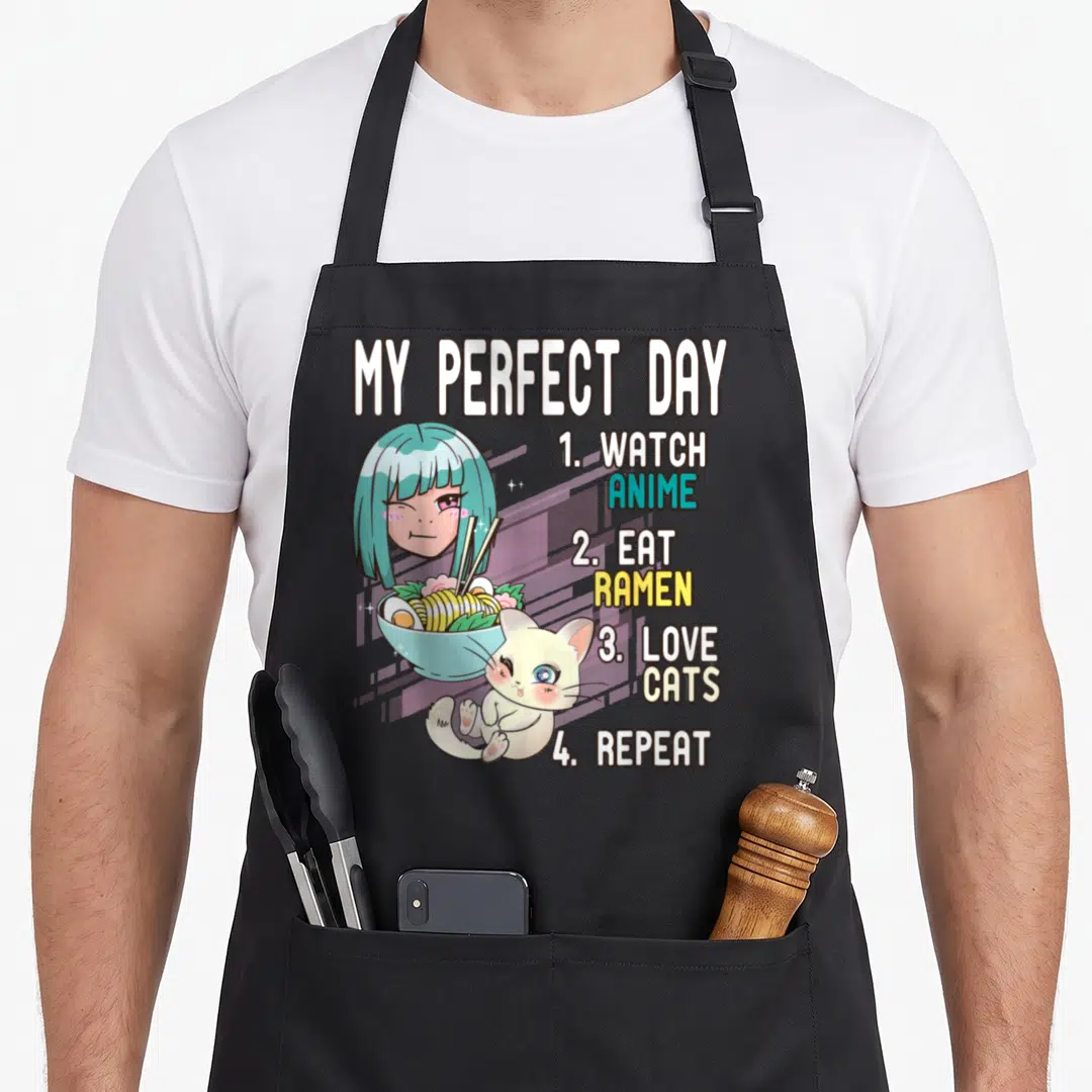 Perfect cat apron - Anime girl ramen bowl cat My Perfect Day watch eat love repeat text — shown on a black cotton canvas apron against a white background