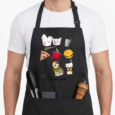 Icon gilmore girls apron - Grid of food icons including takeout boxes, red mug, burger, and dog above Gilmore girls text — shown on a black cotton canvas apron against a white background
