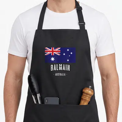Balmain australian apron - Distressed Australian flag with Balmain and Australia text printed on canvas — shown on a black cotton canvas apron against a white background