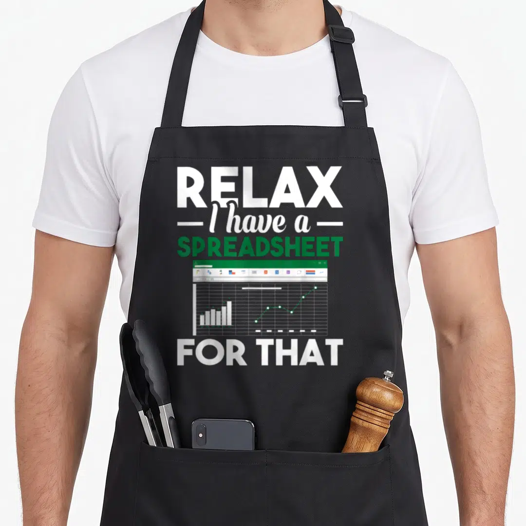 Spreadsheet accountant apron - RELAX I have a SPREADSHEET FOR THAT text above a window graphic with a bar chart — shown on a black cotton canvas apron against a white background