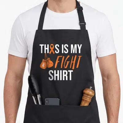 Funny kidney ribbon apron - This Is My Fight Shirt text with orange boxing gloves and awareness ribbons — shown on a black cotton canvas apron against a white background