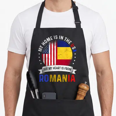 Patriot romanian apron - Globe split between US and Romanian flags with patriotic text and distressed texture — shown on a black cotton canvas apron against a white background