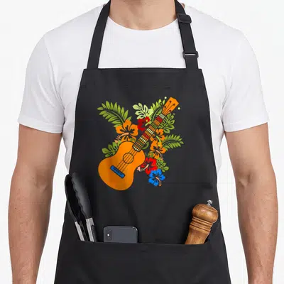 Ukuele ukulele apron - Orange cartoon guitar with red blue orange hibiscus and green tropical leaves — shown on a black cotton canvas apron against a white background