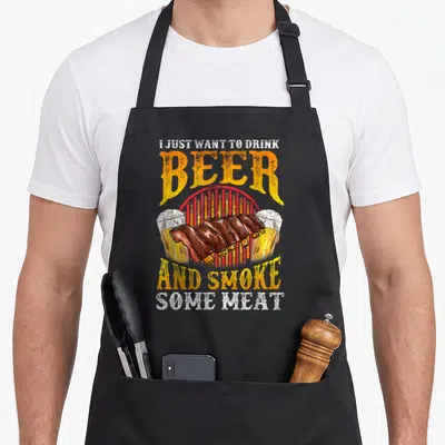 Griller meat aprons - Ribs and two beer glasses with stacked text on red striped background — shown on a black cotton canvas apron against a white background