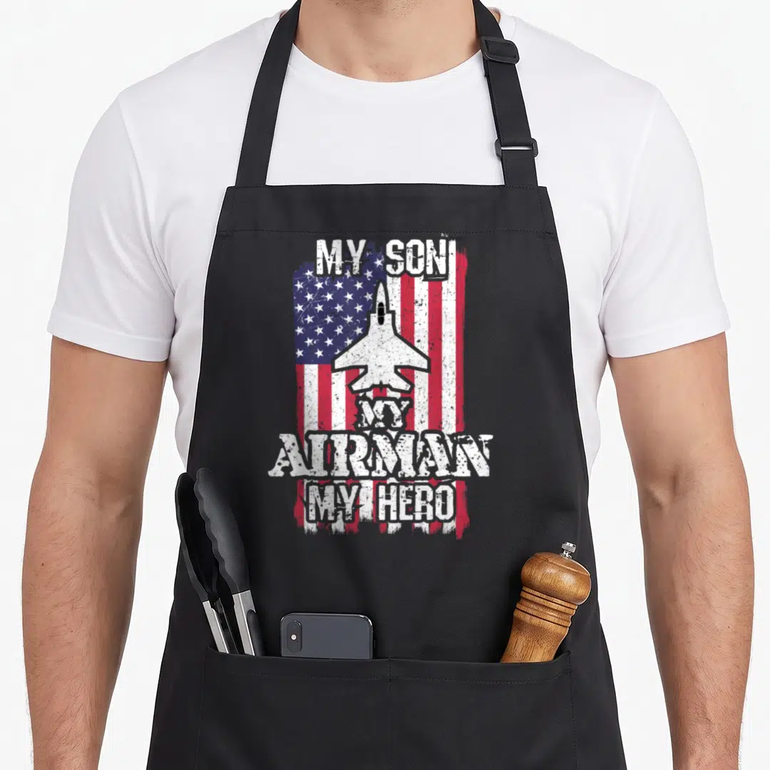 Airman patriotic apron - Distressed US flag with jet fighter and My Son My Airman My Hero text — shown on a black cotton canvas apron against a white background