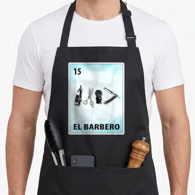 Barbero mexican apron - Number 15 card with clipper scissors brush and straight razor inside blue frame — shown on a black cotton canvas apron against a white background