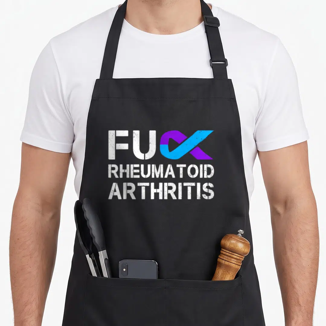 Rheumatoid arthritis ribbon apron - White FU letters beside purple blue ribbon shaped like CK, stacked RHEUMATOID — shown on a black cotton canvas apron against a white background