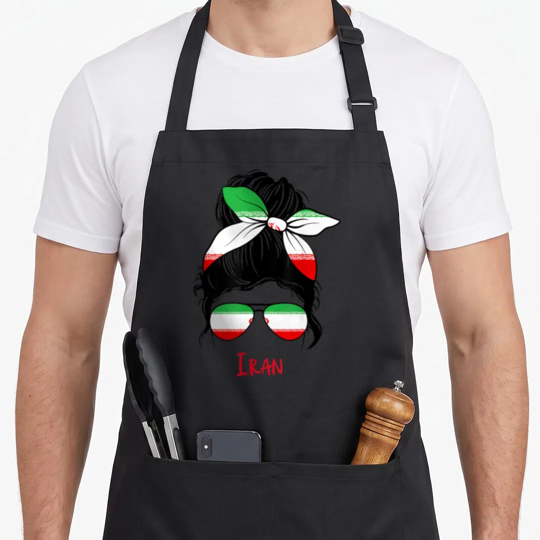 Iranian persian girl apron - Cartoon woman head with flag sunglasses and IRAN text in red green white black — shown on a black cotton canvas apron against a white background