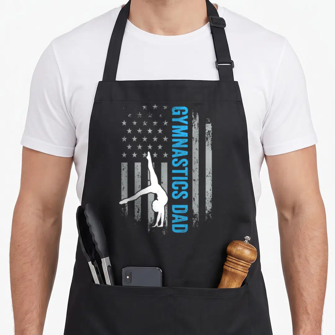 Gymnast american flag apron - White gymnast handstand silhouette over distressed blue and white flag pattern — shown on a black cotton canvas apron against a white background