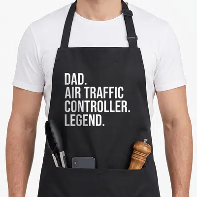 Traffic aviation apron - White stacked text reading DAD AIR TRAFFIC CONTROLLER LEGEND — shown on a black cotton canvas apron against a white background