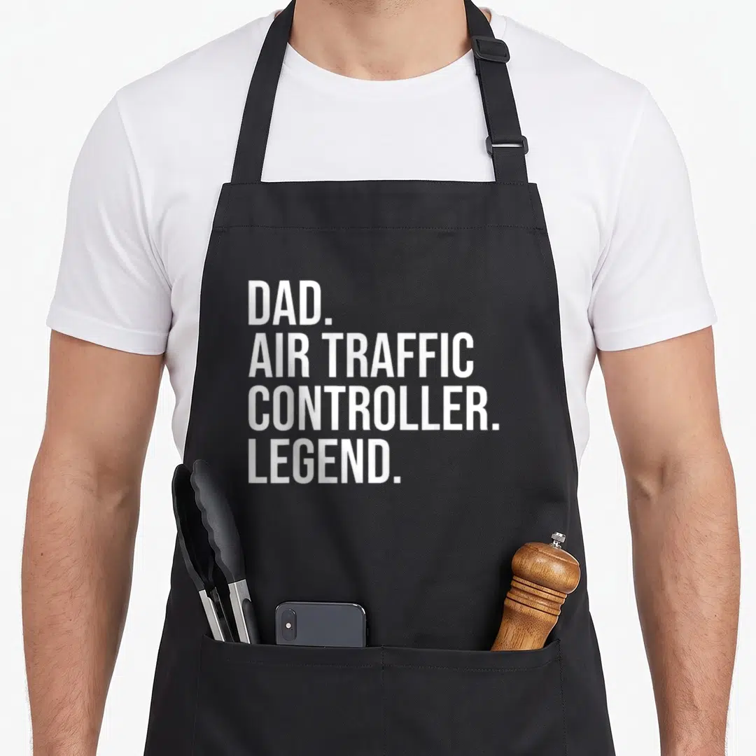 Traffic aviation apron - White stacked text reading DAD AIR TRAFFIC CONTROLLER LEGEND — shown on a black cotton canvas apron against a white background