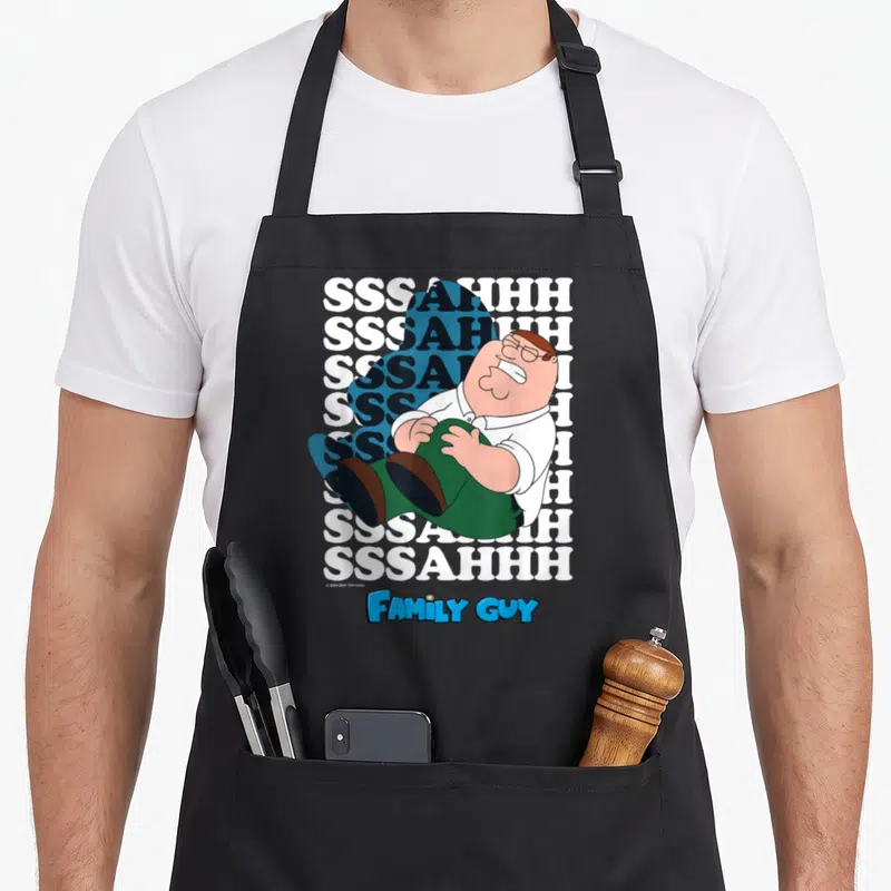 Knee griffin apron - Peter Griffin holding knee over SSSAHHH text and Family Guy logo — shown on a black cotton canvas apron against a white background