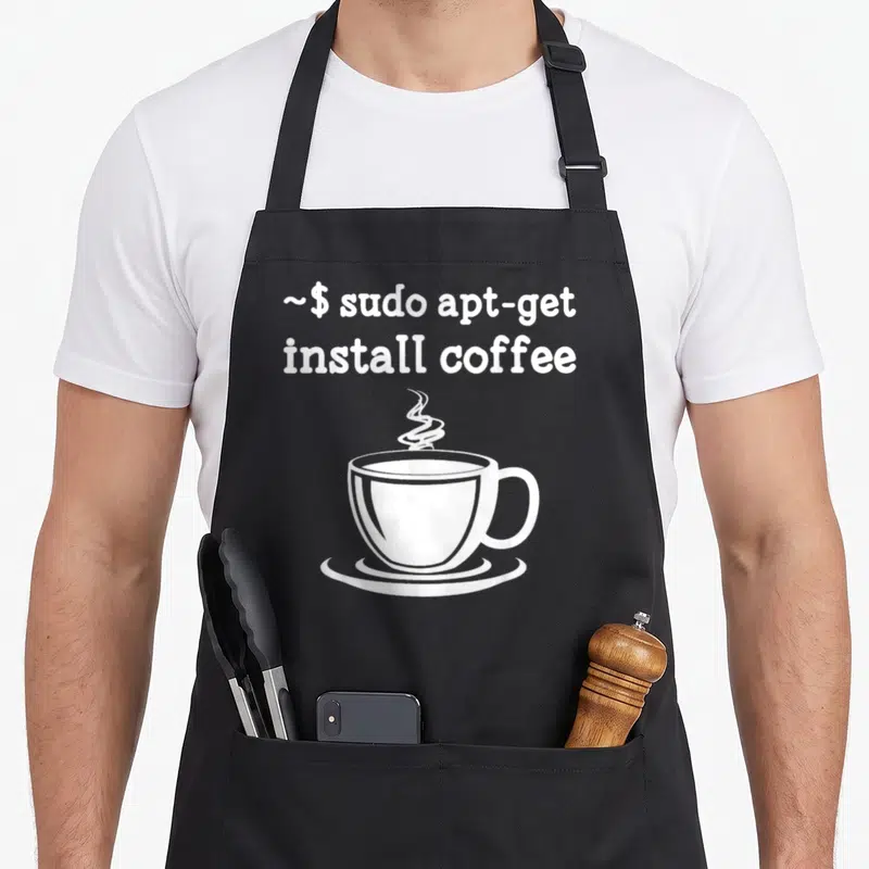 Linux coffee apron - White terminal command text and steaming coffee cup on black background — shown on a black cotton canvas apron against a white background