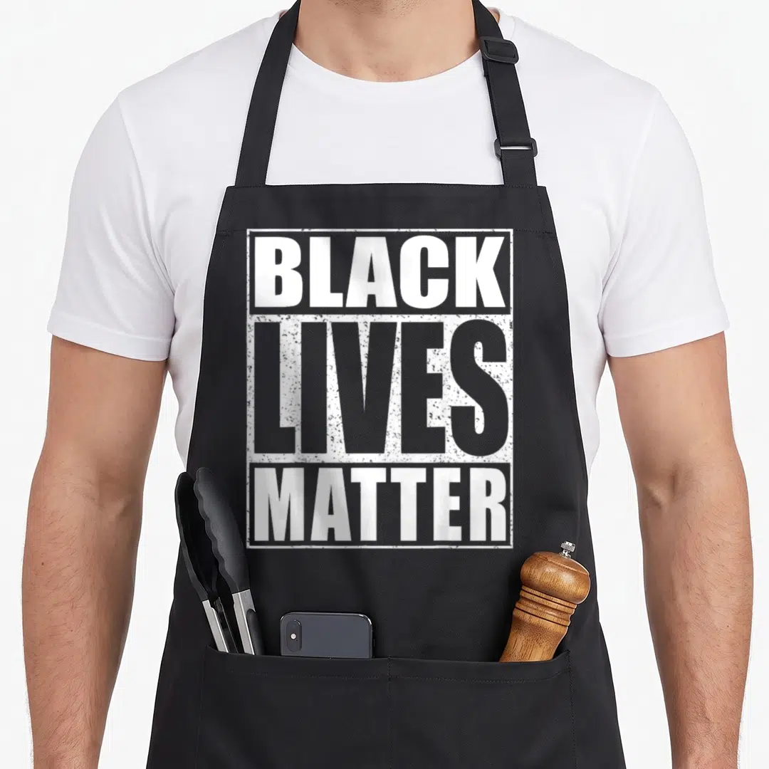Matter blm camping apron - White stacked text BLACK LIVES MATTER inside distressed white border — shown on a black cotton canvas apron against a white background