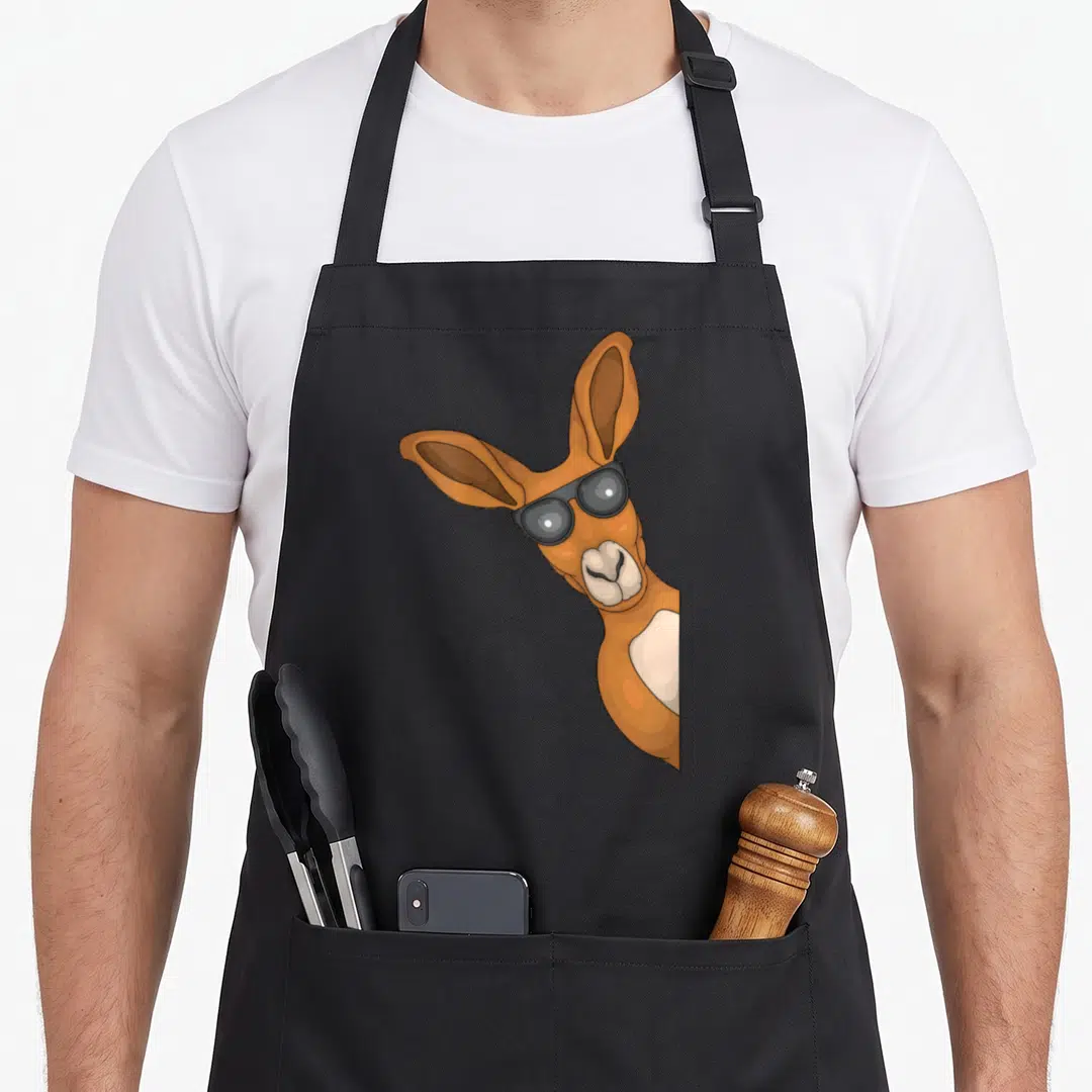 Australia animal kangaroo apron - Cartoon kangaroo head with sunglasses in brown and beige on the right side — shown on a black cotton canvas apron against a white background