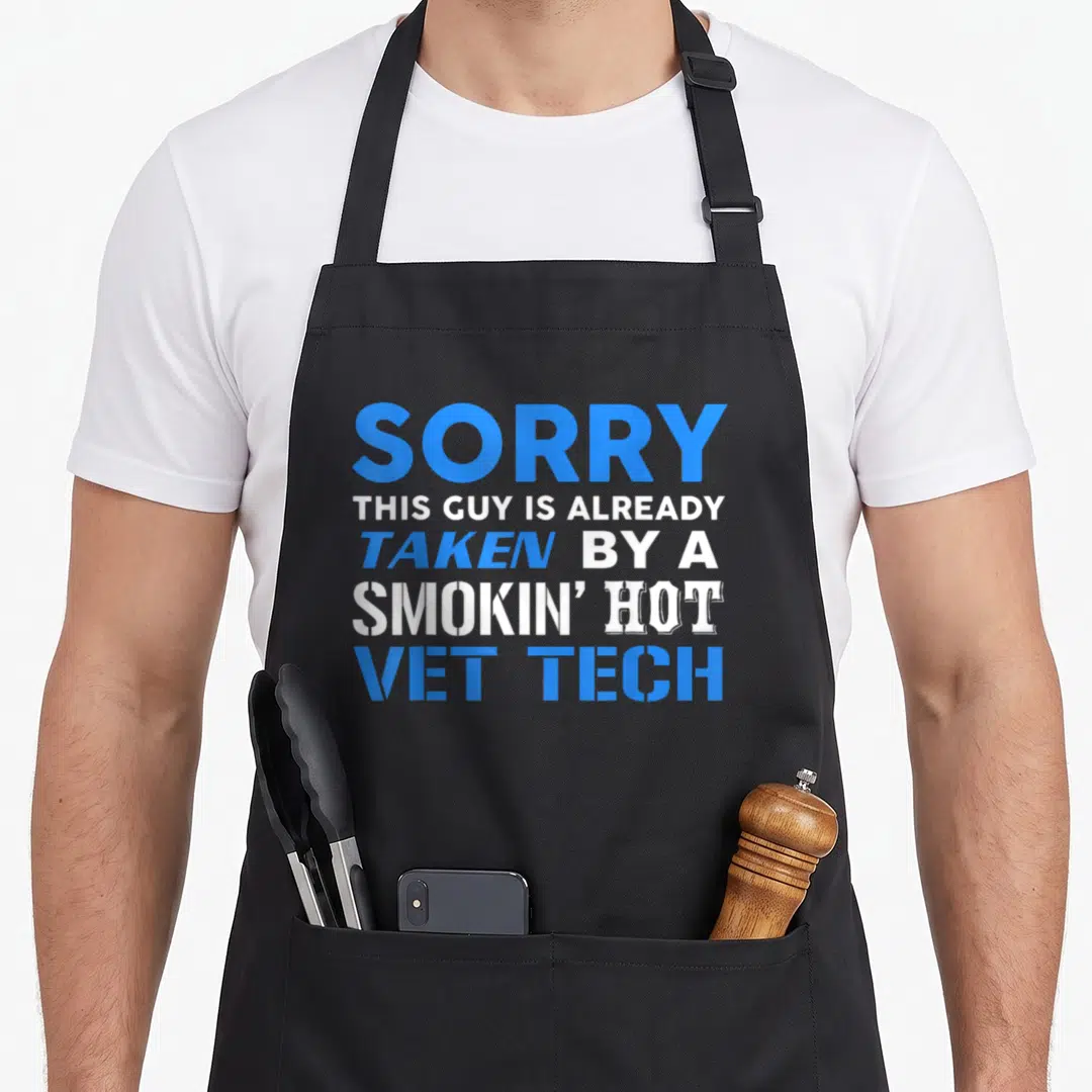 Taken husband apron - Blue and white stacked text reading Sorry This Guy Is Already Taken By A Smokin Hot Vet Tech — shown on a black cotton canvas apron against a white background