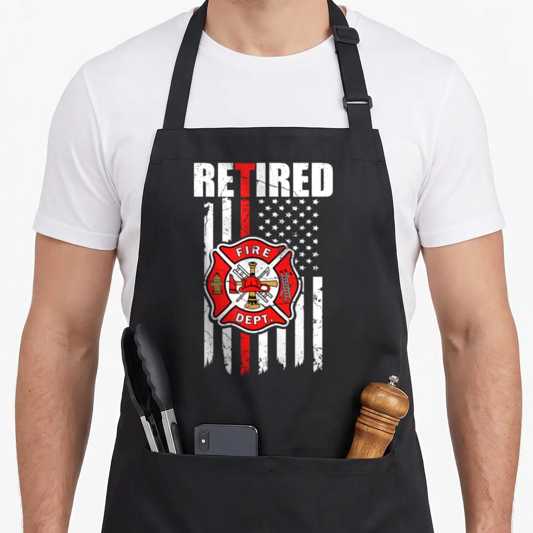 Flag firefighter cooking apron - Distressed American flag with red line and Fire Dept Maltese cross emblem — shown on a black cotton canvas apron against a white background