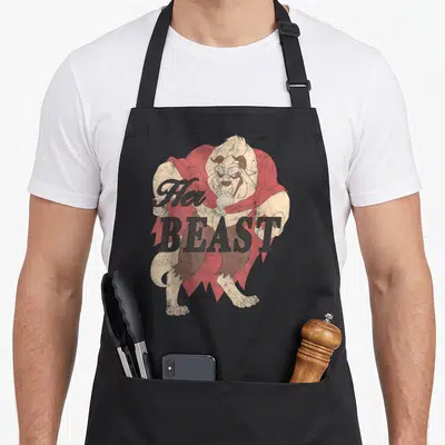 Beast bridal apron - Beast character in red cape with Her BEAST text in distressed grey lettering — shown on a black cotton canvas apron against a white background