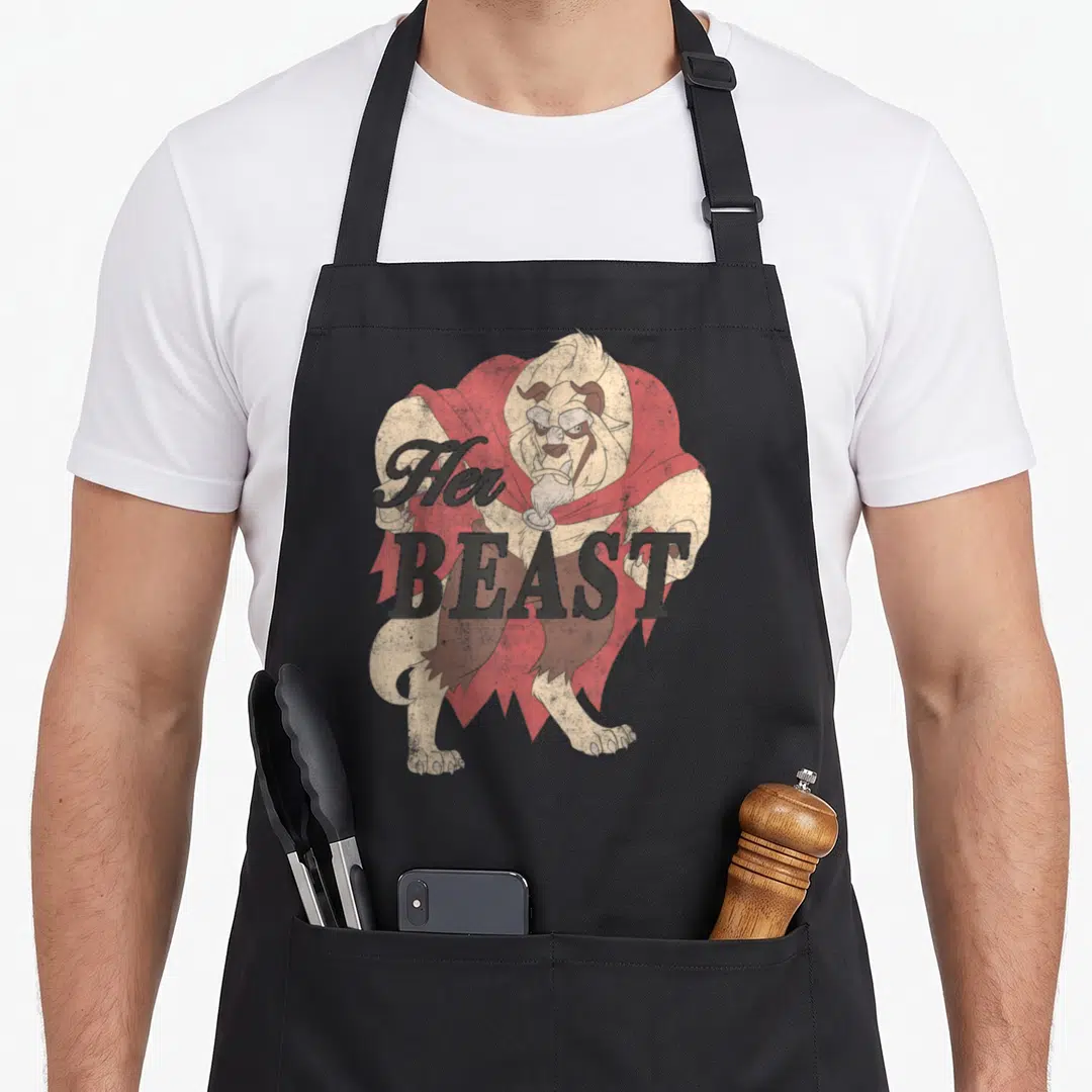 Beast bridal apron - Beast character in red cape with Her BEAST text in distressed grey lettering — shown on a black cotton canvas apron against a white background
