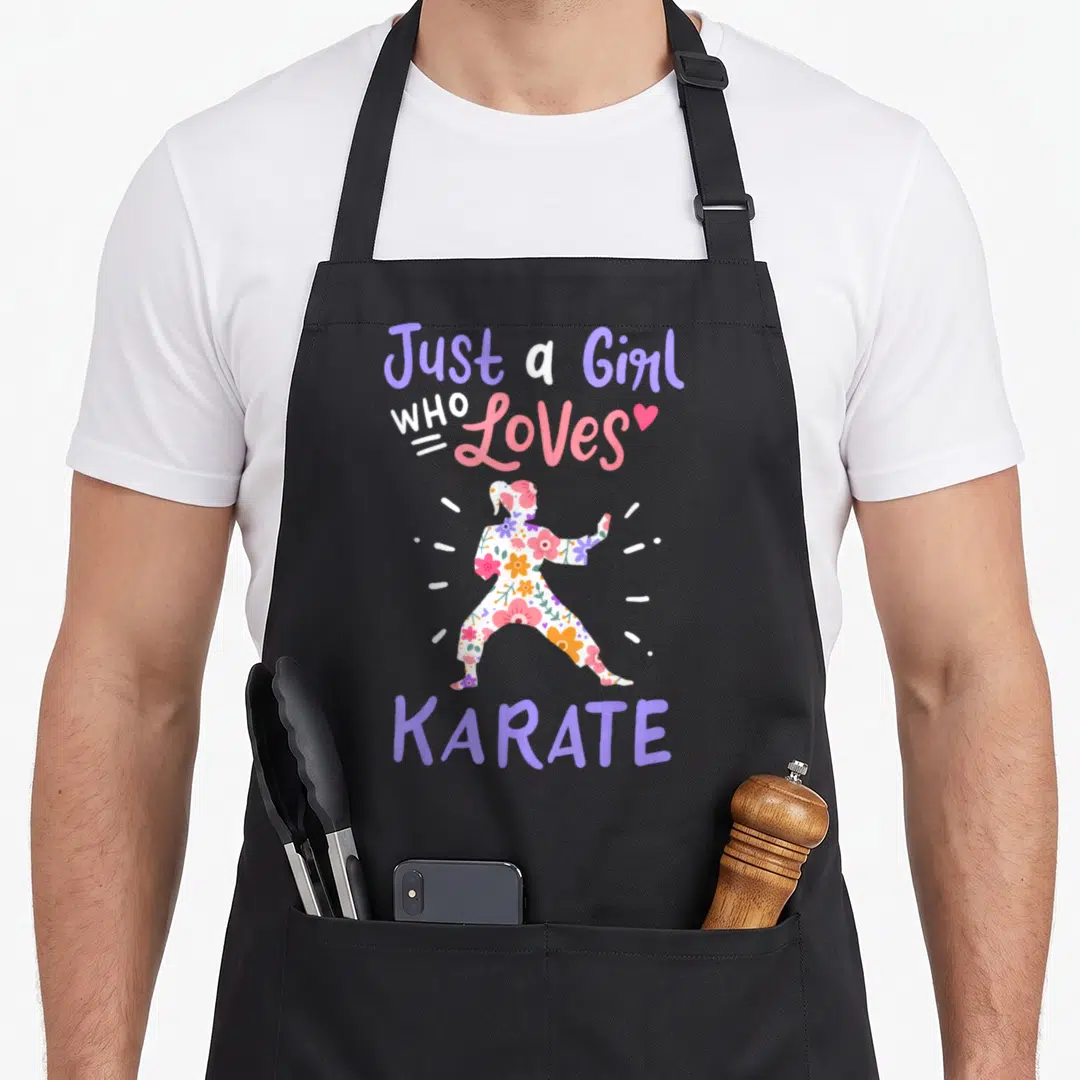 Hobby i love karate apron - Floral karate girl silhouette surrounded by Just a Girl Who Loves Karate text in purple — shown on a black cotton canvas apron against a white background