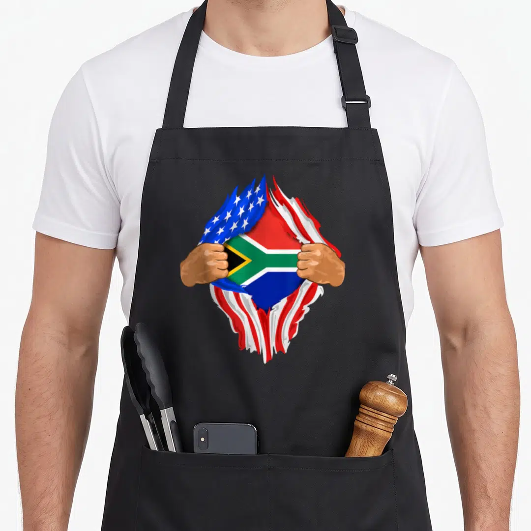 Blood south african apron - Two hands tearing USA flag revealing South African flag with red blue green yellow stripes — shown on a black cotton canvas apron against a white background