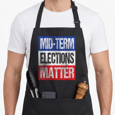 Midterm political aprons - MID-TERM ELECTIONS MATTER text on distressed blue white and red bands — shown on a black cotton canvas apron against a white background
