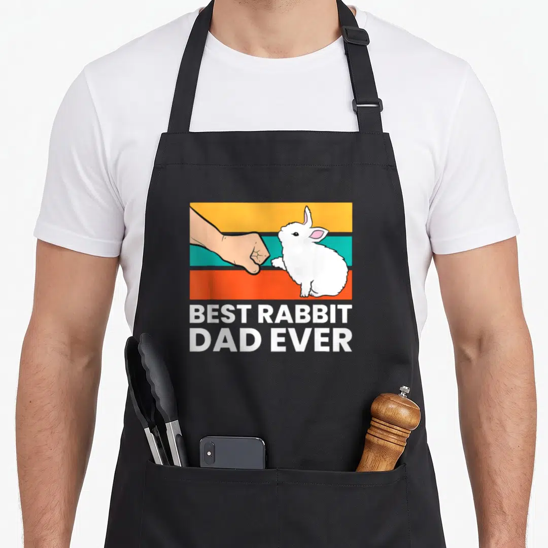 Funny rabbit apron - White rabbit and human fist bump over orange teal and red stripes with bold text — shown on a black cotton canvas apron against a white background