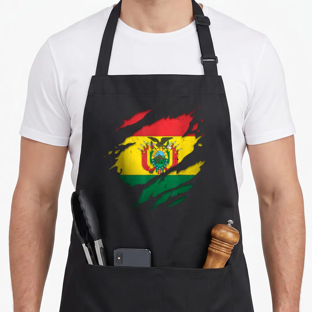 Bolivian torn apron - Flag of Bolivia tearing through grey surface with red yellow green colors — shown on a black cotton canvas apron against a white background