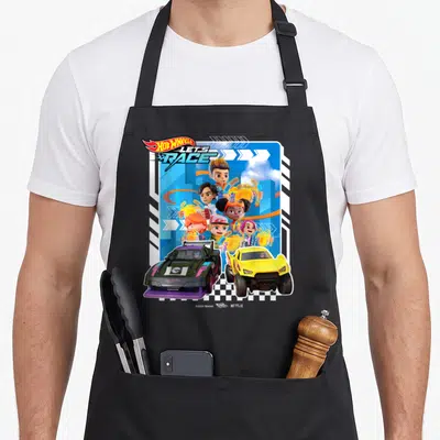 Race mac apron - Five cartoon characters holding trophies above two race cars with HOT WHEELS LET'S RACE logo — shown on a black cotton canvas apron against a white background